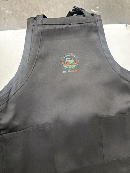 Full-color deli logo printed on a black work apron