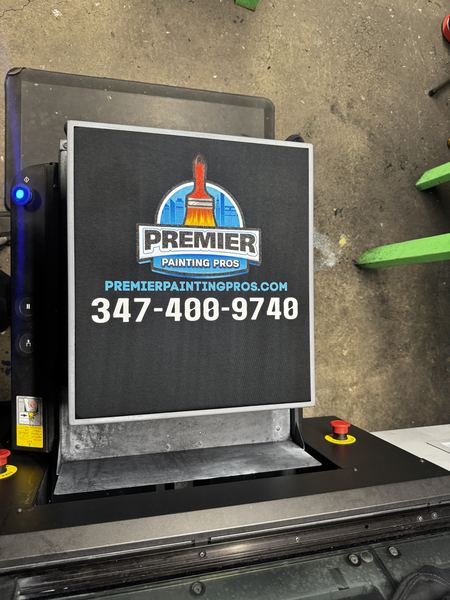 Full-color company logo, website and phone number printed on a black work tee