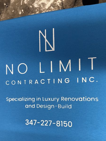 White No Limit Contracting logo, tagline and phone number screen printed on a turquoise shirt