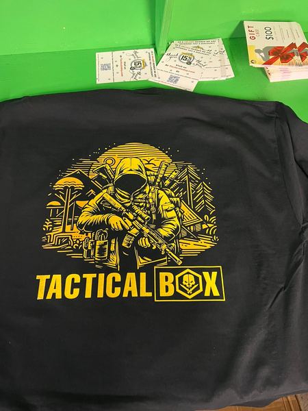 Yellow one-color screen print of the Tactical Box logo on a black tee